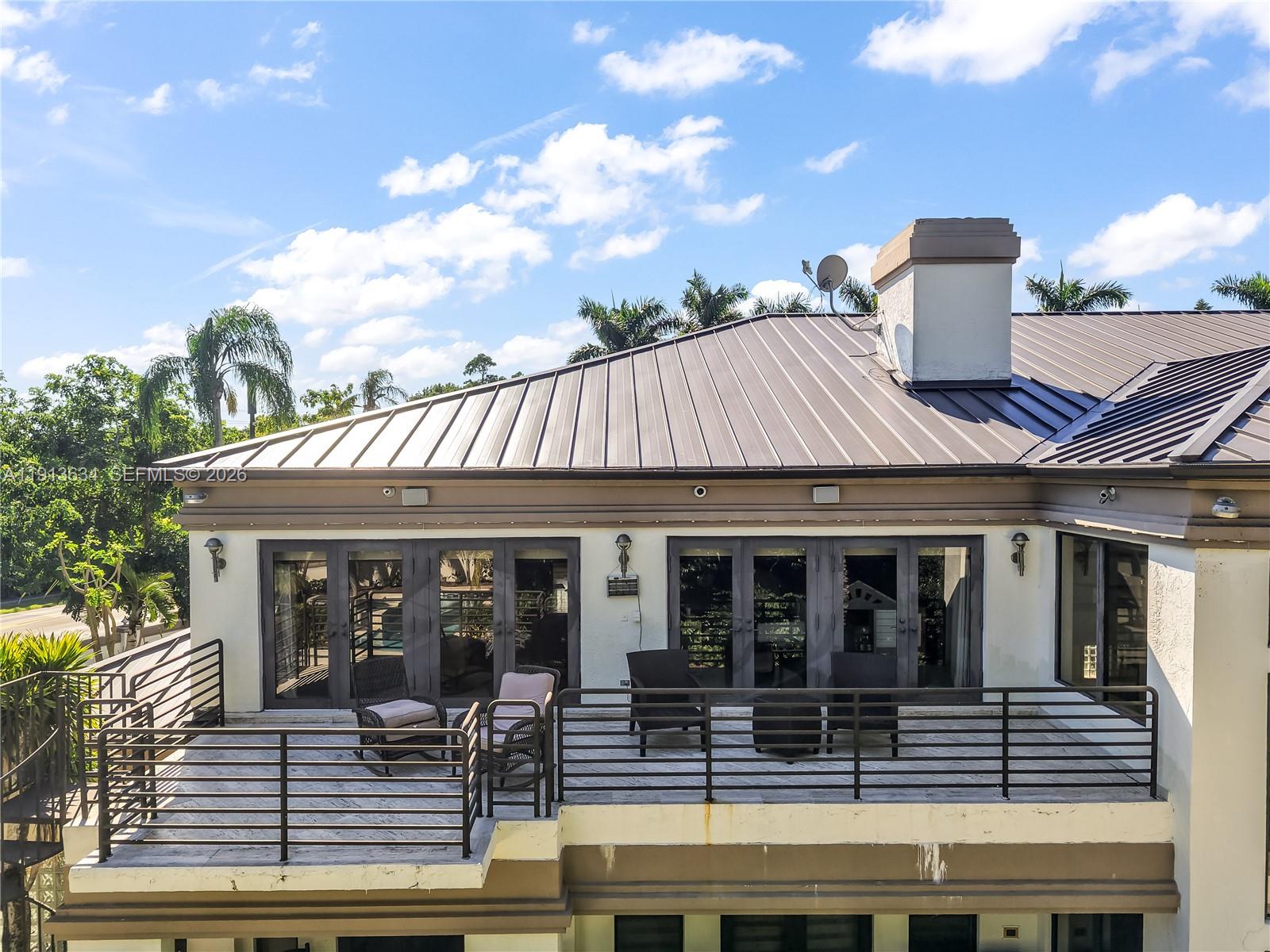 10395 Southwest 67th Avenue Pinecrest, FL 33156 - Photo 9 of 94 a front view of a house with porch