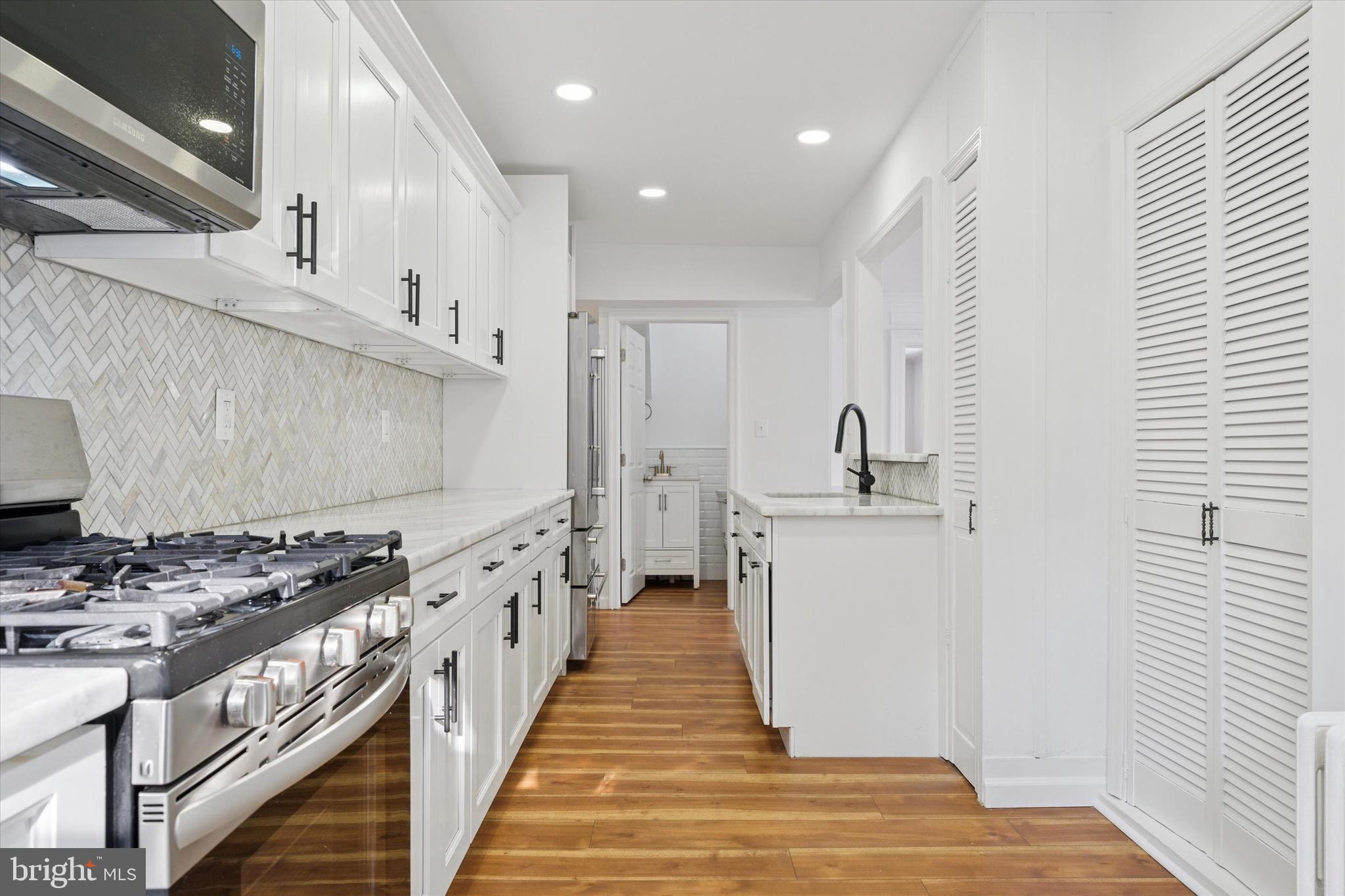 226 Upland Road Merion Station, PA 19066 - Photo 15 of 30 a kitchen with stainless steel appliances a stove a sink and a refrigerator