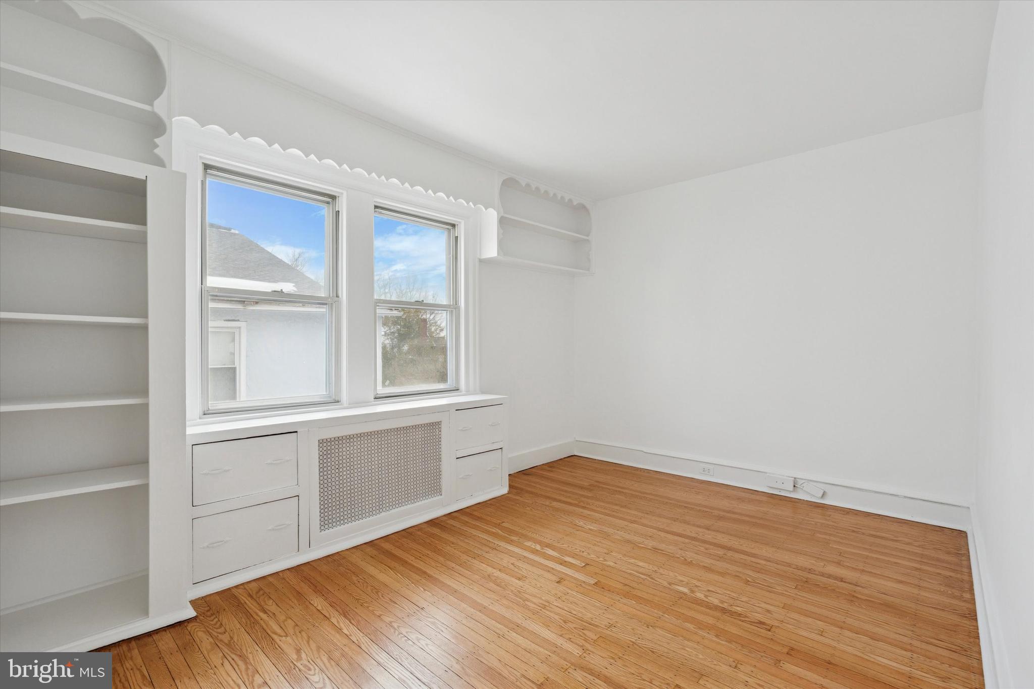 226 Upland Road Merion Station, PA 19066 - Photo 17 of 30 a view of an empty room with wooden floor and a window