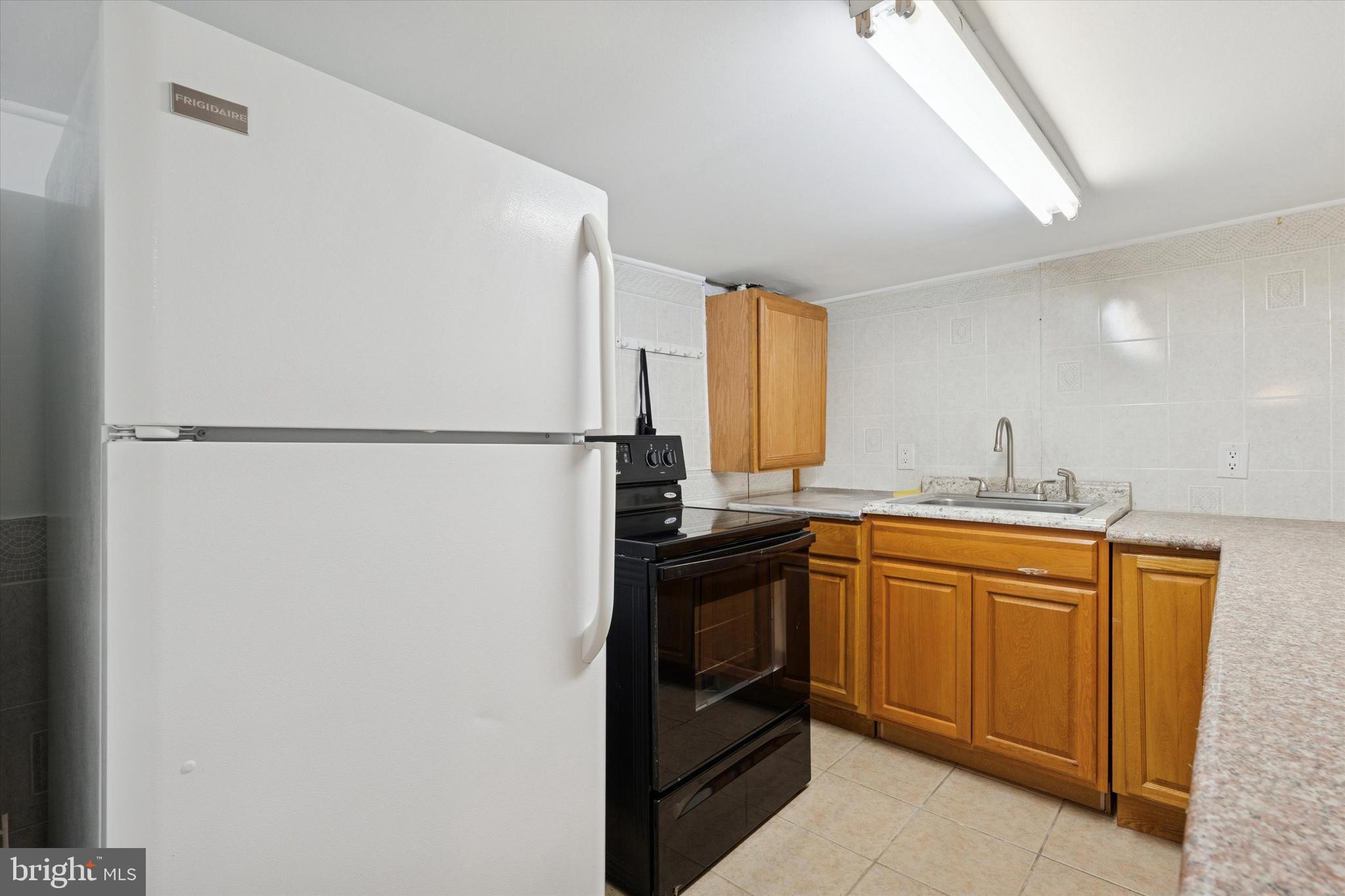 226 Upland Road Merion Station, PA 19066 - Photo 27 of 30 a kitchen with stainless steel appliances granite countertop a refrigerator a sink and dishwasher