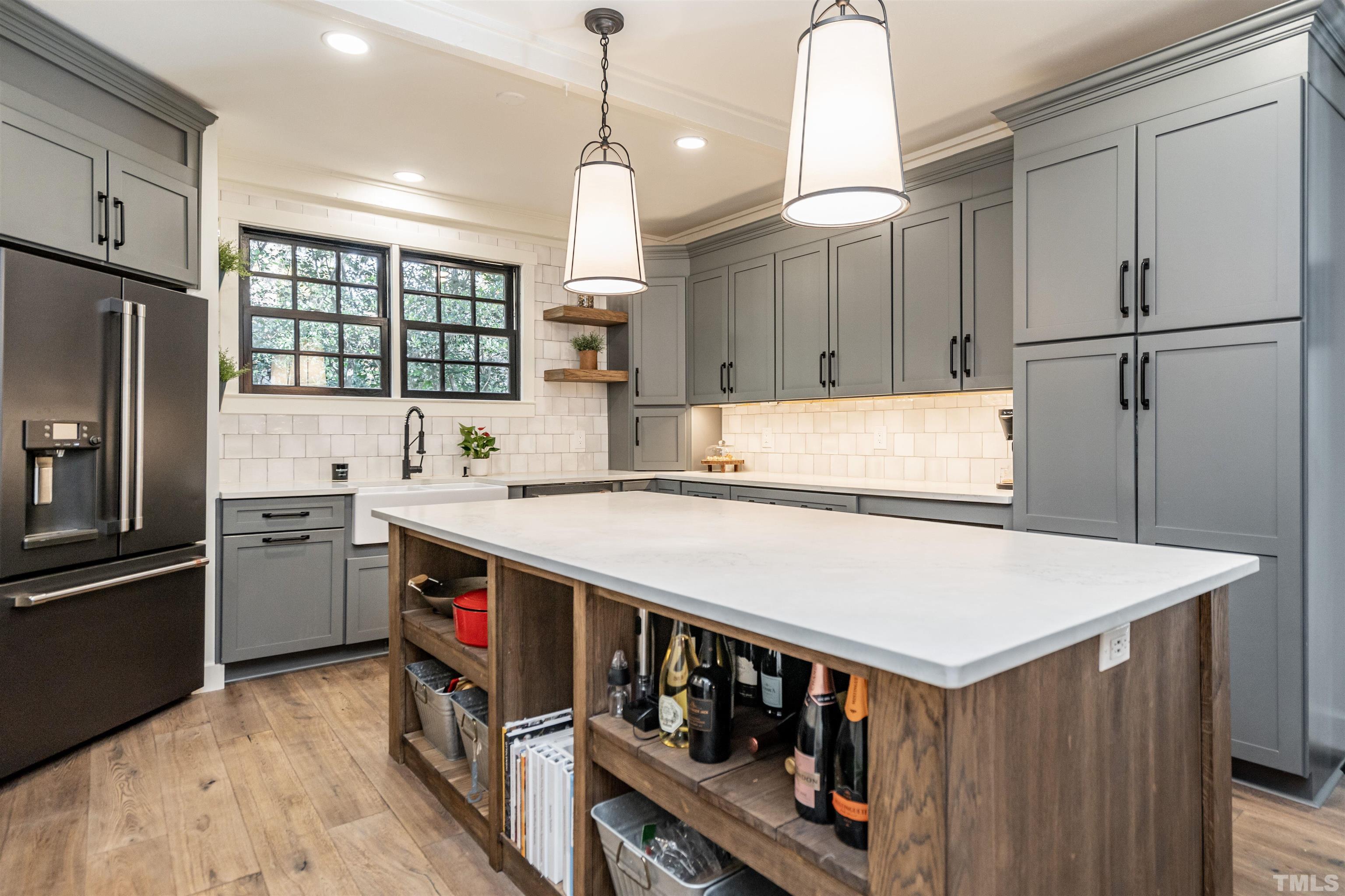 2412 Ridge Road Raleigh, NC 27612 - Photo 14 of 43 a kitchen that has a lot of cabinets a sink and a stove in it