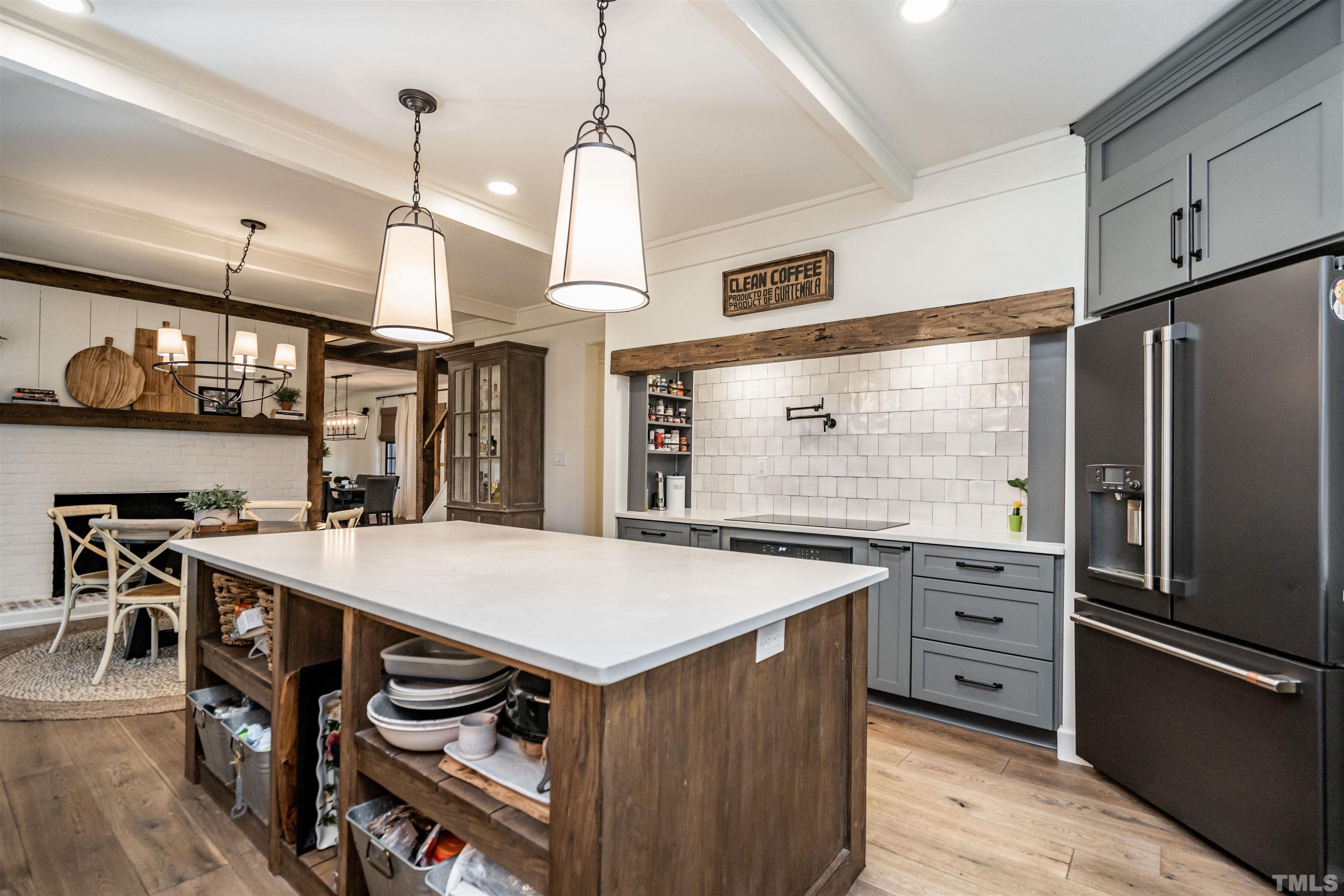 2412 Ridge Road Raleigh, NC 27612 - Photo 17 of 43 a kitchen with a stove a refrigerator and a table