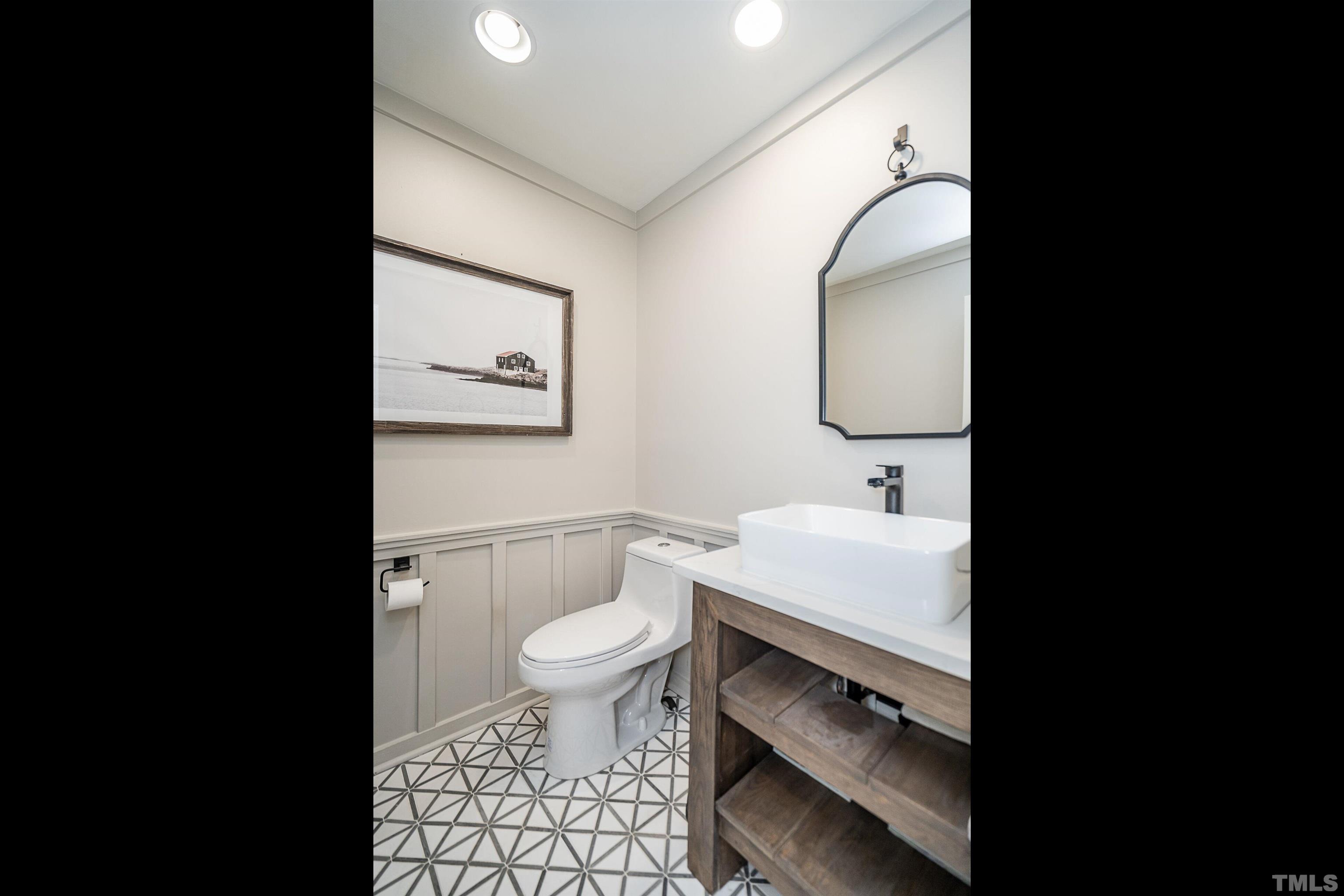 2412 Ridge Road Raleigh, NC 27612 - Photo 19 of 43 a bathroom with a sink toilet and vanity