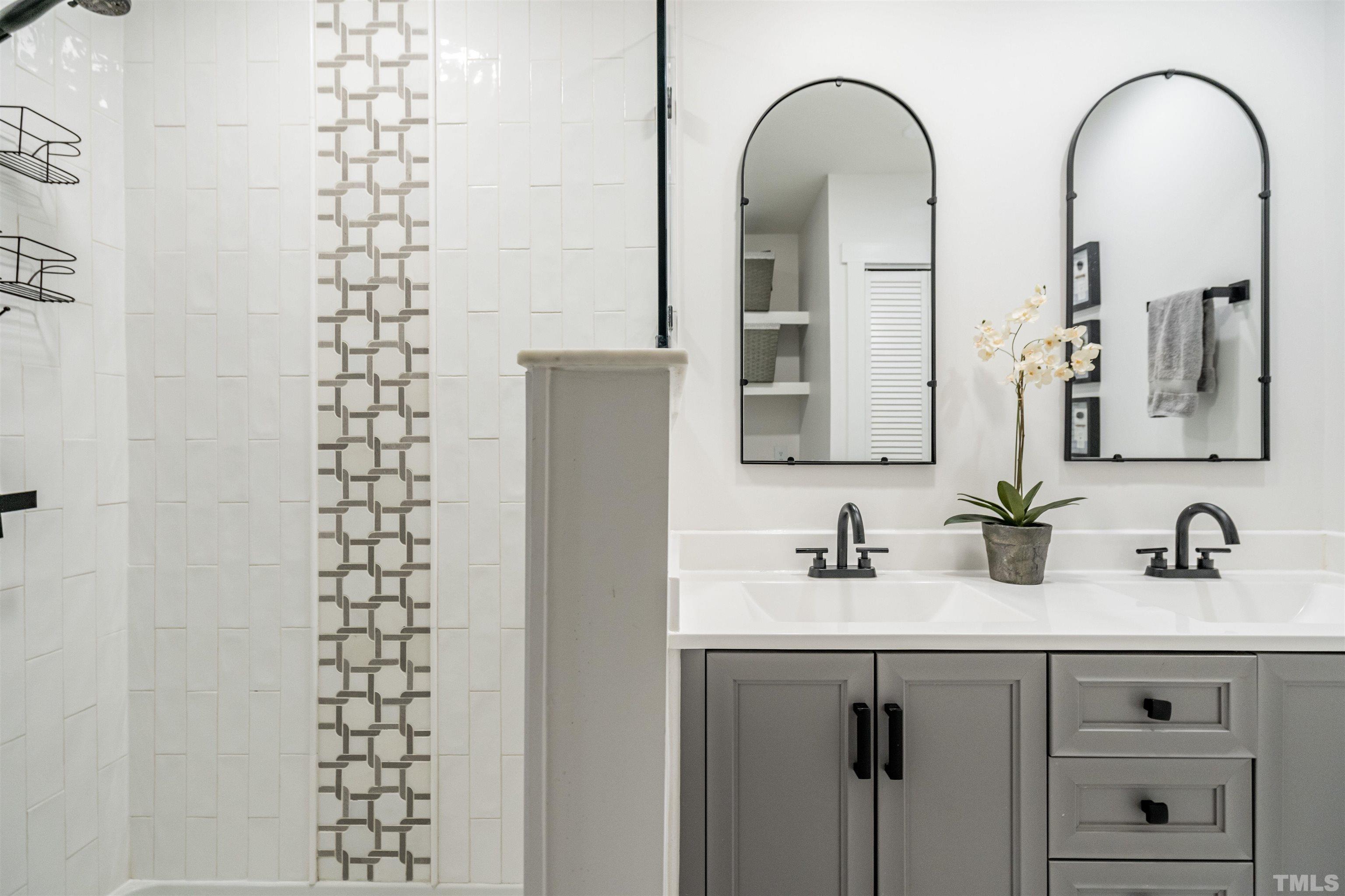 2412 Ridge Road Raleigh, NC 27612 - Photo 23 of 43 a bathroom with a double vanity sink and a mirror