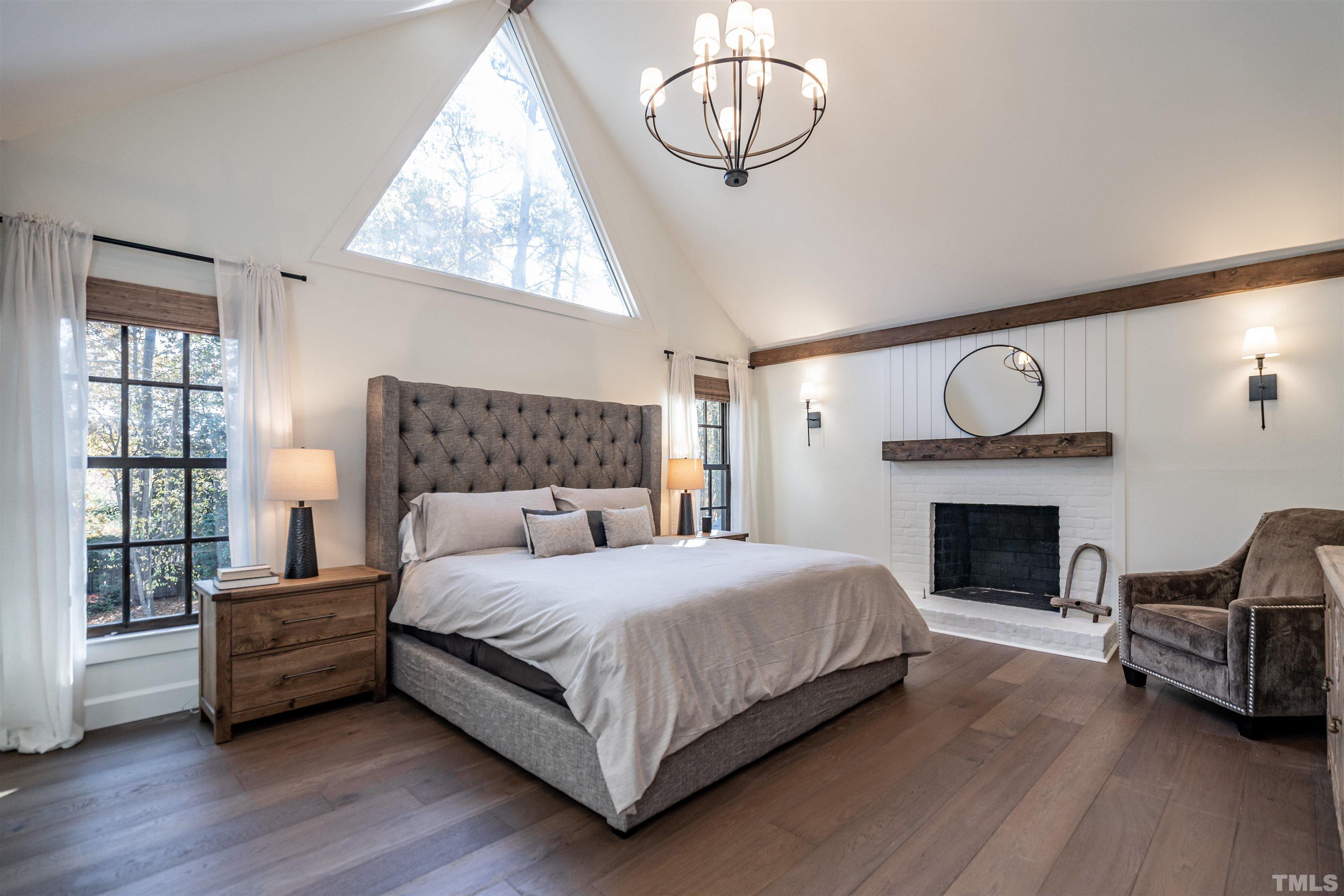 2412 Ridge Road Raleigh, NC 27612 - Photo 29 of 43 a bedroom with a bed and a fireplace