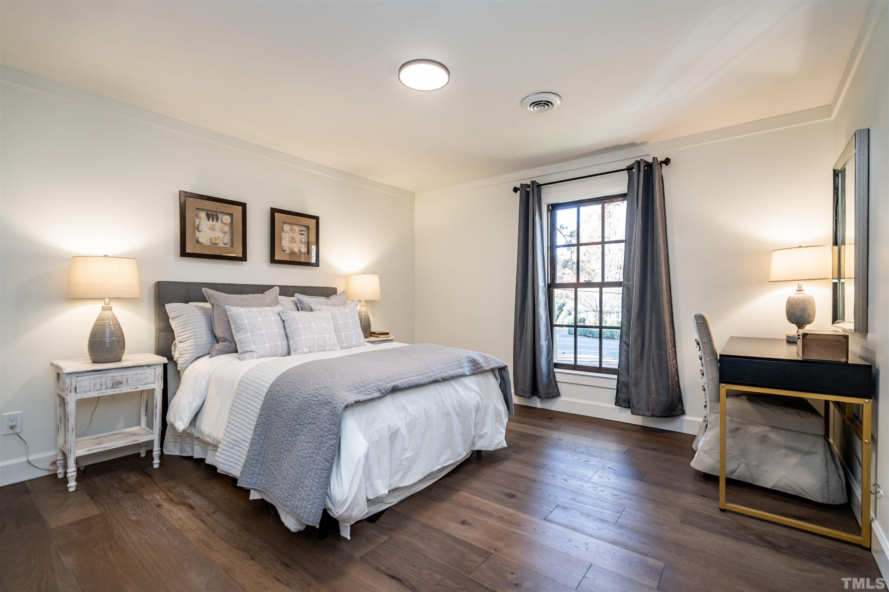 2412 Ridge Road Raleigh, NC 27612 - Photo 32 of 43 a bedroom with a bed and a window