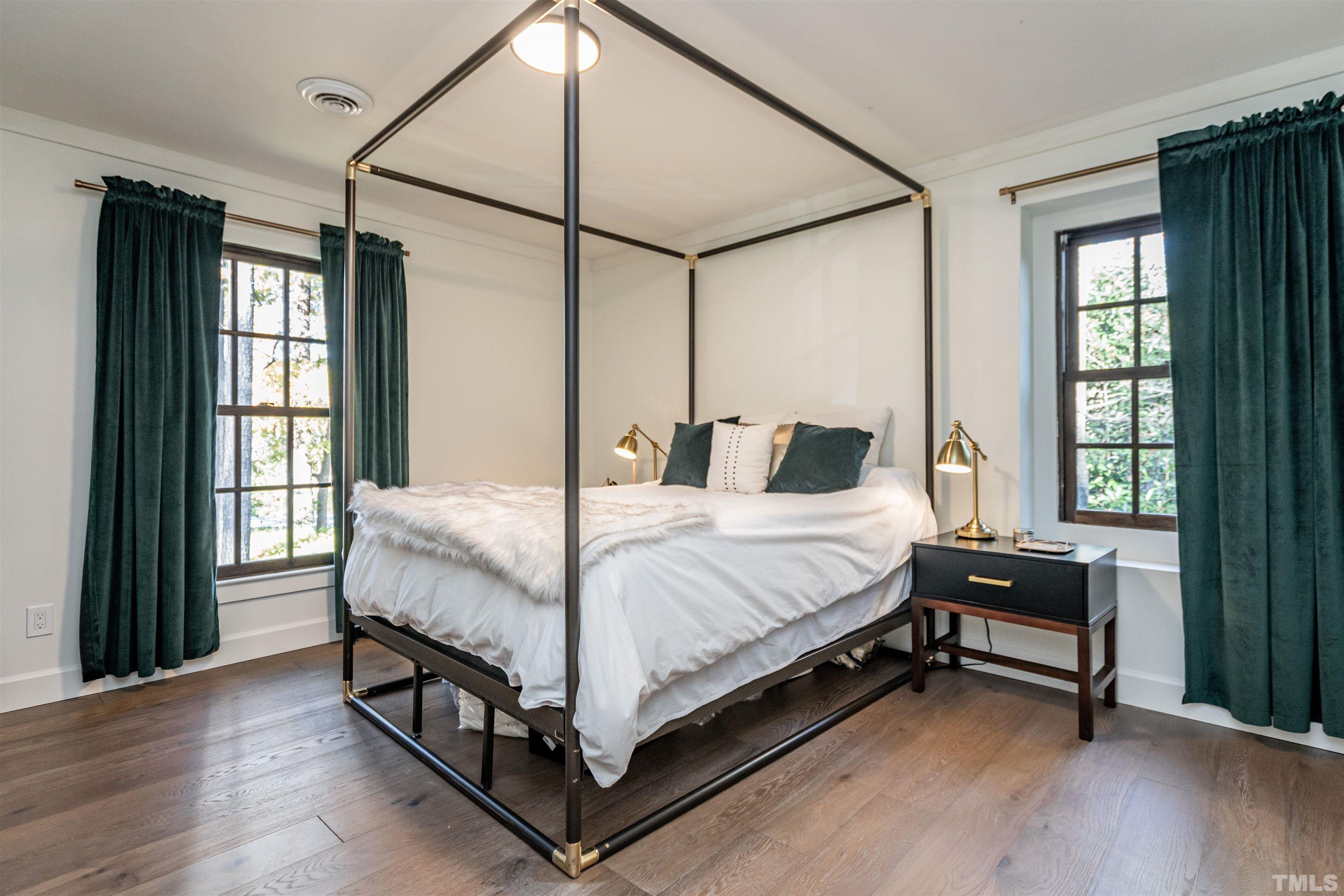 2412 Ridge Road Raleigh, NC 27612 - Photo 34 of 43 a bedroom with a bed window and a mirror
