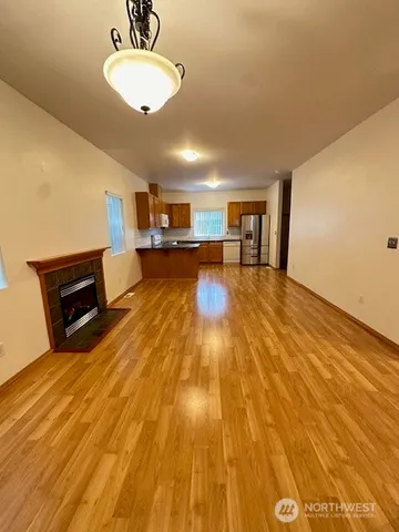 a view of kitchen with dining room and wooden floor