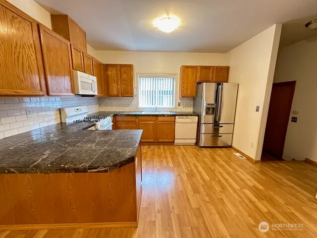 a kitchen with wooden floors and a sink