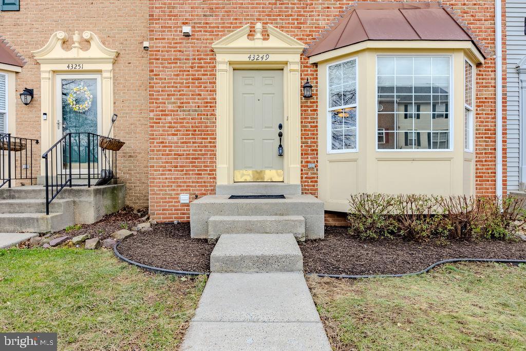 43249 Clearnight Terrace Ashburn, VA 20147 - Photo 11 of 39 a front view of a house with garden