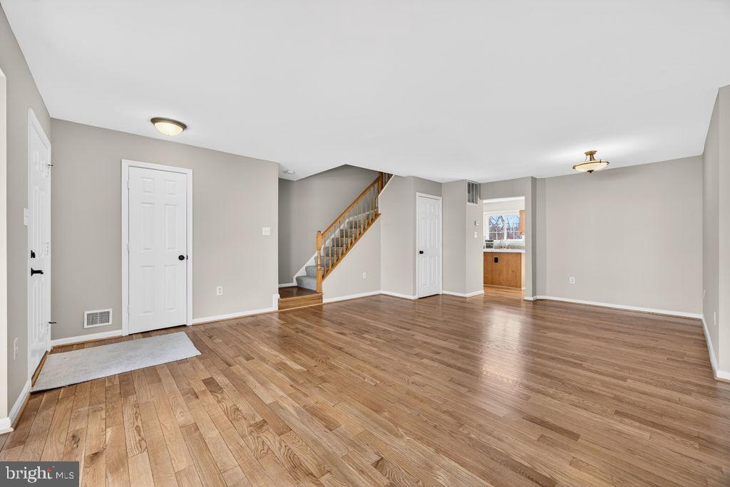 43249 Clearnight Terrace Ashburn, VA 20147 - Photo 12 of 39 a view of empty room with wooden floor and stairs