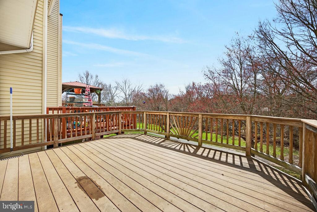 43249 Clearnight Terrace Ashburn, VA 20147 - Photo 18 of 39 a view of wooden balcony with a bench