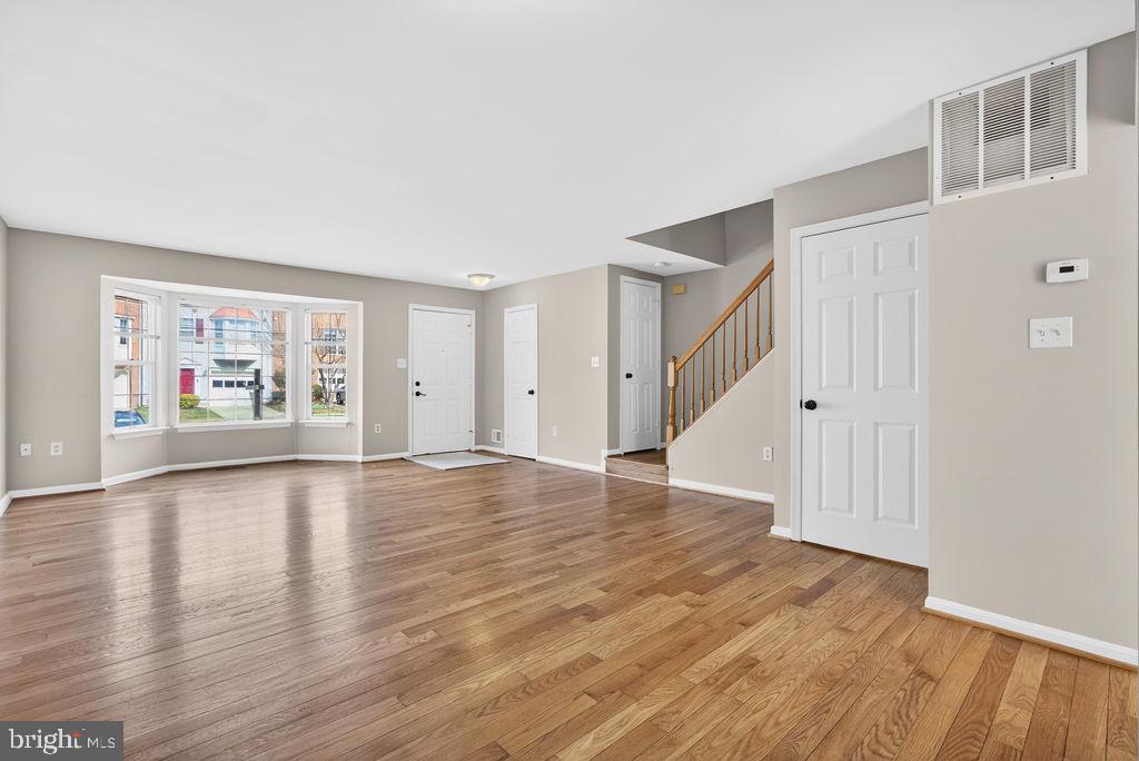 43249 Clearnight Terrace Ashburn, VA 20147 - Photo 2 of 39 wooden floor in an empty room with a window