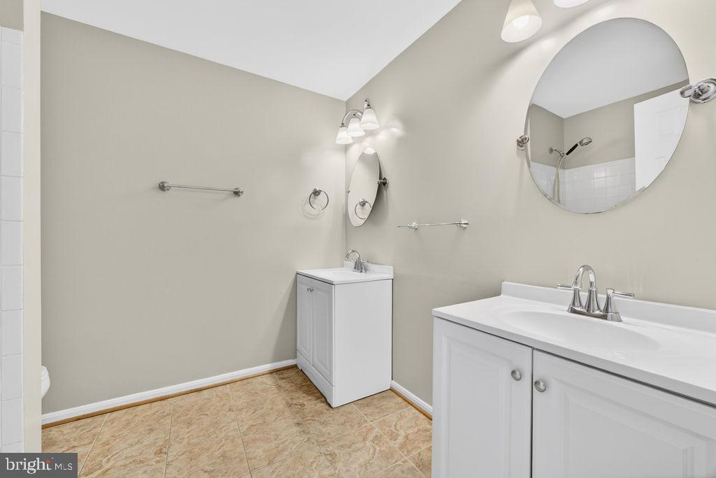 43249 Clearnight Terrace Ashburn, VA 20147 - Photo 25 of 39 a bathroom with a sink a mirror and vanity