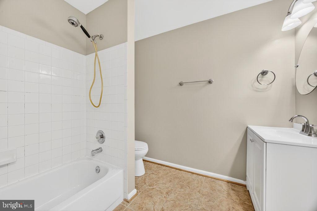 43249 Clearnight Terrace Ashburn, VA 20147 - Photo 26 of 39 a bathroom with a sink a toilet and shower