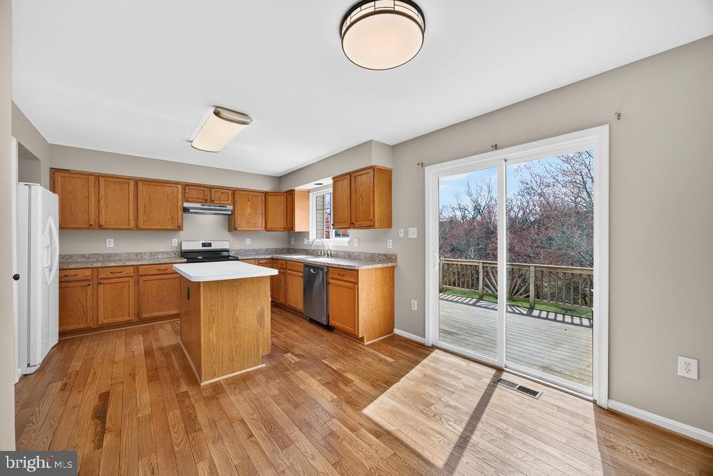 43249 Clearnight Terrace Ashburn, VA 20147 - Photo 3 of 39 a kitchen with stainless steel appliances granite countertop a stove a sink and a refrigerator