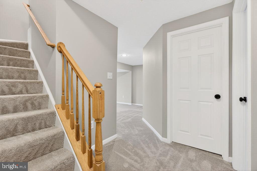 43249 Clearnight Terrace Ashburn, VA 20147 - Photo 32 of 39 a view of staircase with wooden floor and white walls