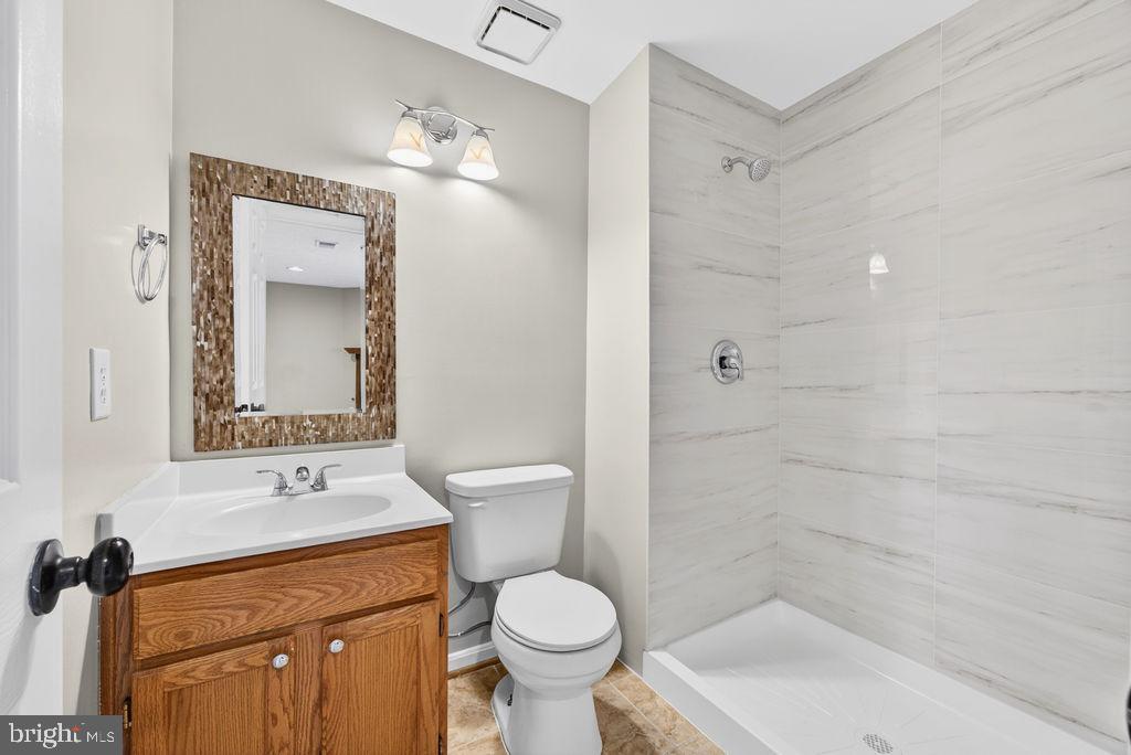43249 Clearnight Terrace Ashburn, VA 20147 - Photo 36 of 39 a bathroom with a sink toilet and shower