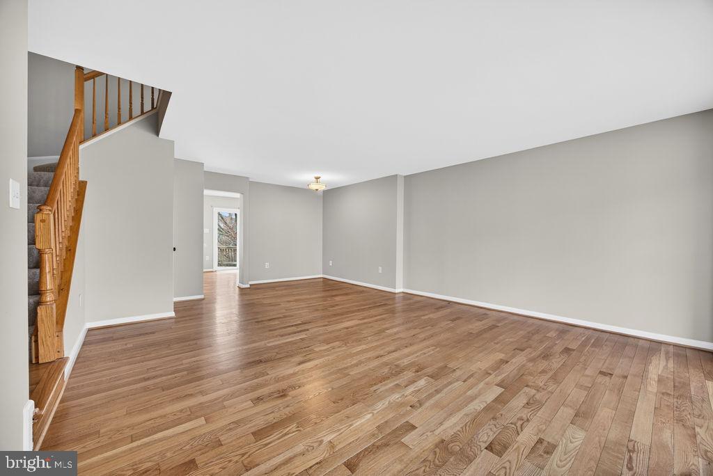43249 Clearnight Terrace Ashburn, VA 20147 - Photo 4 of 39 a view of an empty room with wooden floor and a window