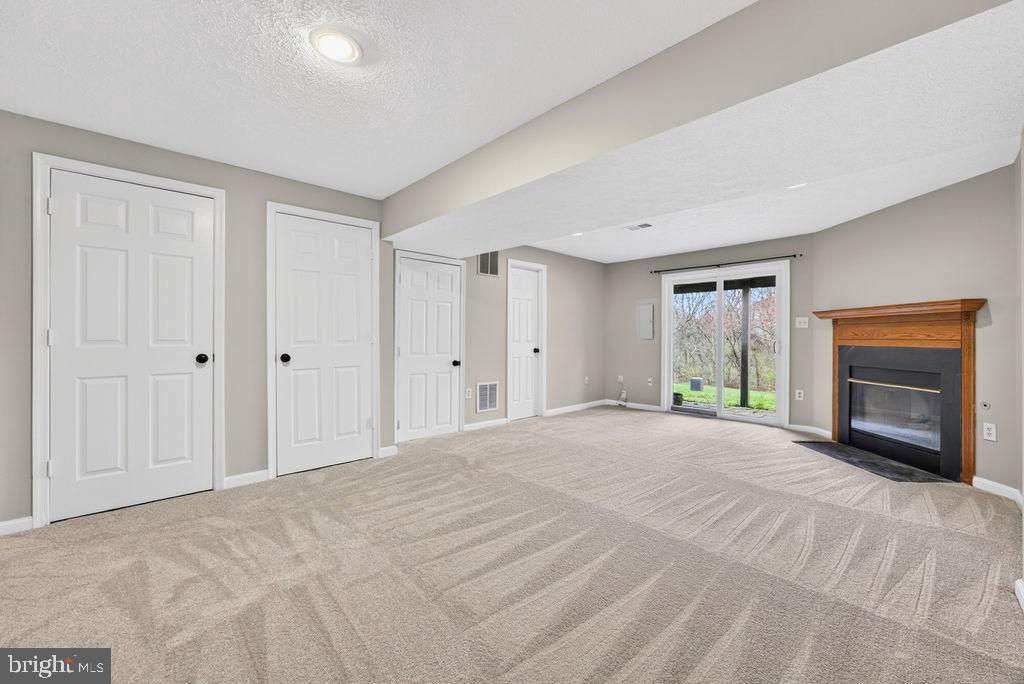 43249 Clearnight Terrace Ashburn, VA 20147 - Photo 5 of 39 a view of an empty room with a window and a fireplace