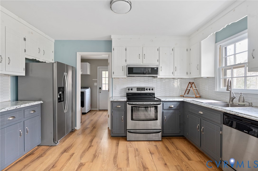 13642 Decidedly Court Midlothian, VA 23112 - Photo 13 of 35 a kitchen with a sink a stove a refrigerator and cabinets