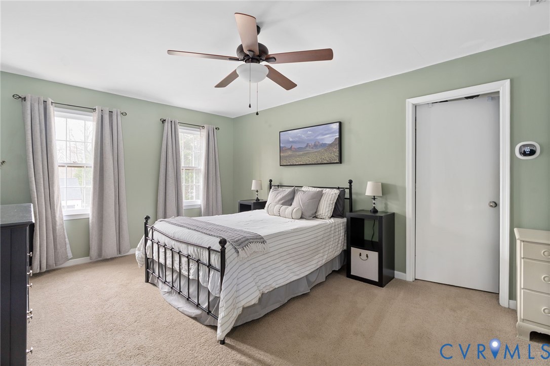 13642 Decidedly Court Midlothian, VA 23112 - Photo 20 of 35 a bedroom with a bed and a chandelier