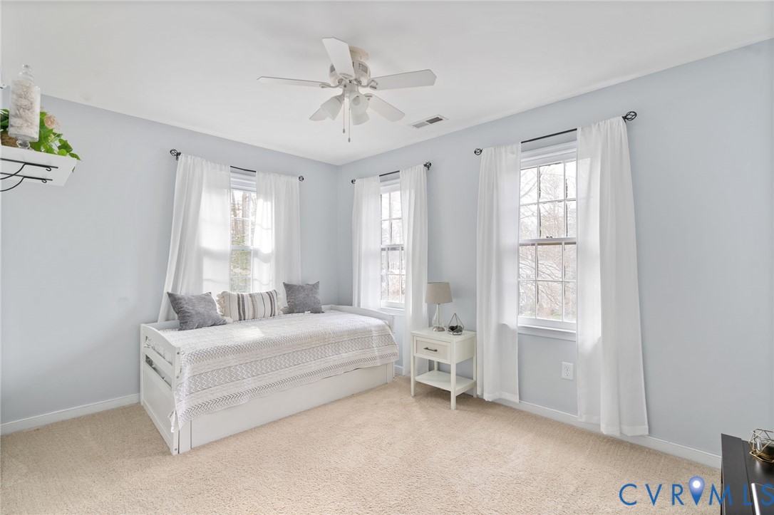 13642 Decidedly Court Midlothian, VA 23112 - Photo 24 of 35 a spacious bedroom with a bed and a window