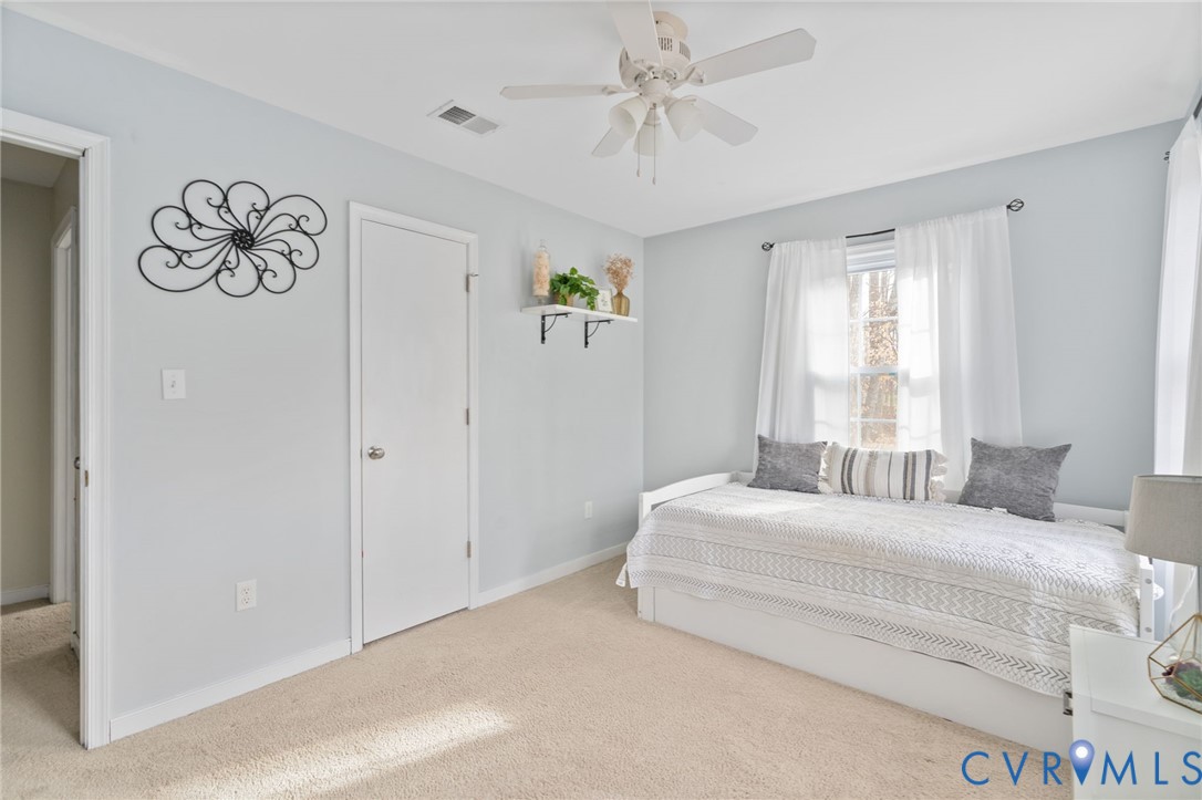 13642 Decidedly Court Midlothian, VA 23112 - Photo 25 of 35 a bedroom with a large bed and a chandelier