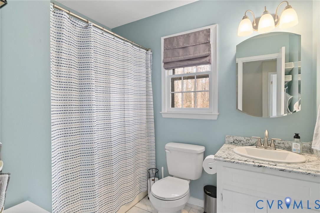 13642 Decidedly Court Midlothian, VA 23112 - Photo 26 of 35 a bathroom with a granite countertop sink and a toilet