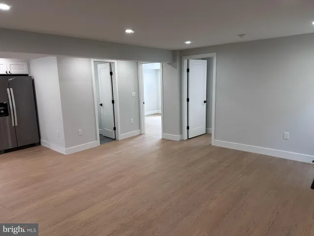 a large kitchen with a sink and refrigerator