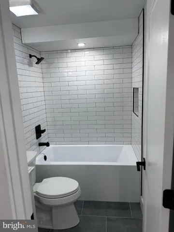 a bathroom with a toilet and a bathtub