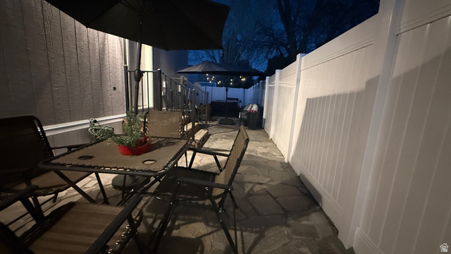 502 West 725 North Logan, UT 84321 - Photo 23 of 25 Patio at twilight featuring outdoor dining space, a patio, a fenced backyard, and a gazebo