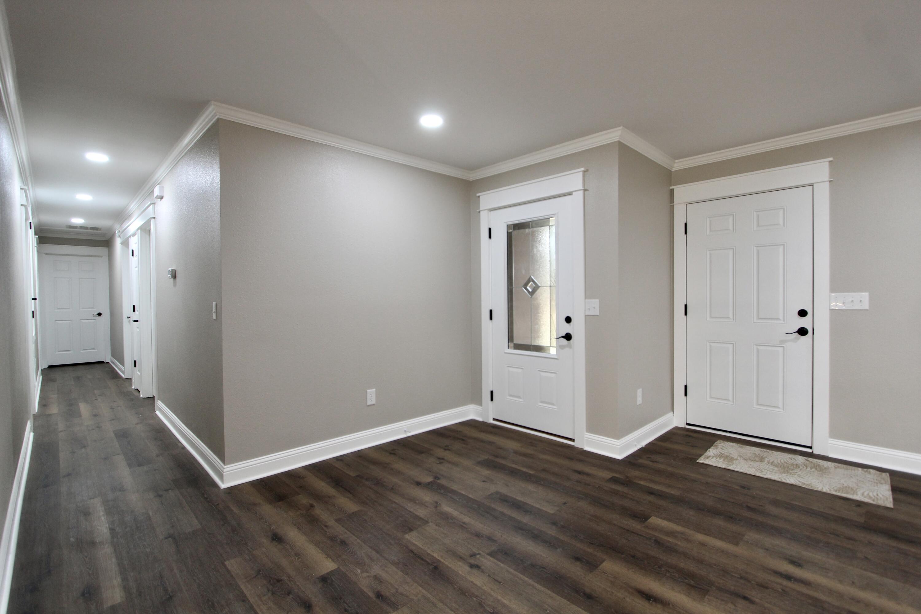 4052 Randi Road Crestview, FL 32539 - Photo 11 of 27 wooden floor in an empty room with a window