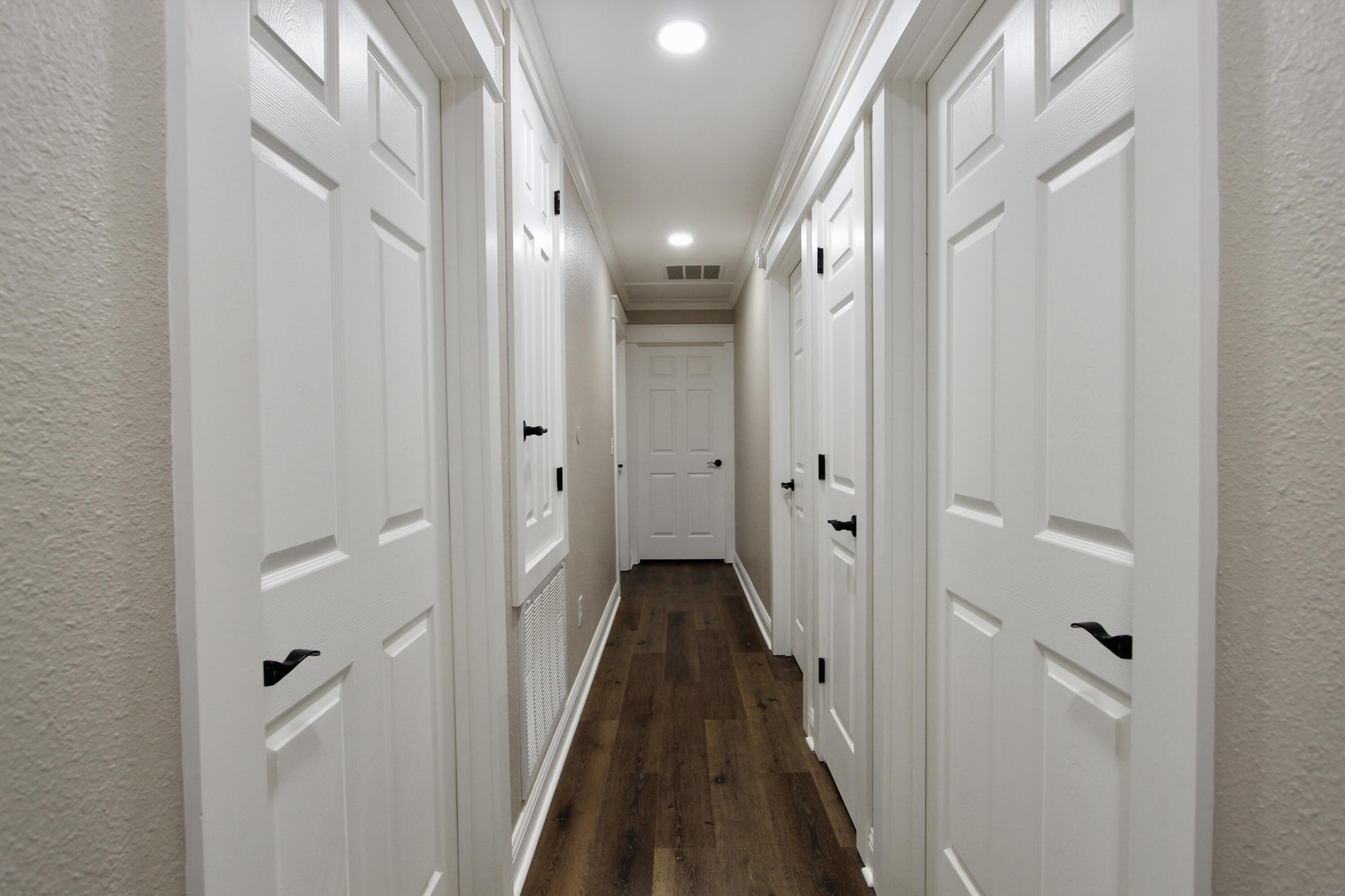 4052 Randi Road Crestview, FL 32539 - Photo 12 of 27 a view of a hallway with closet and wooden floor