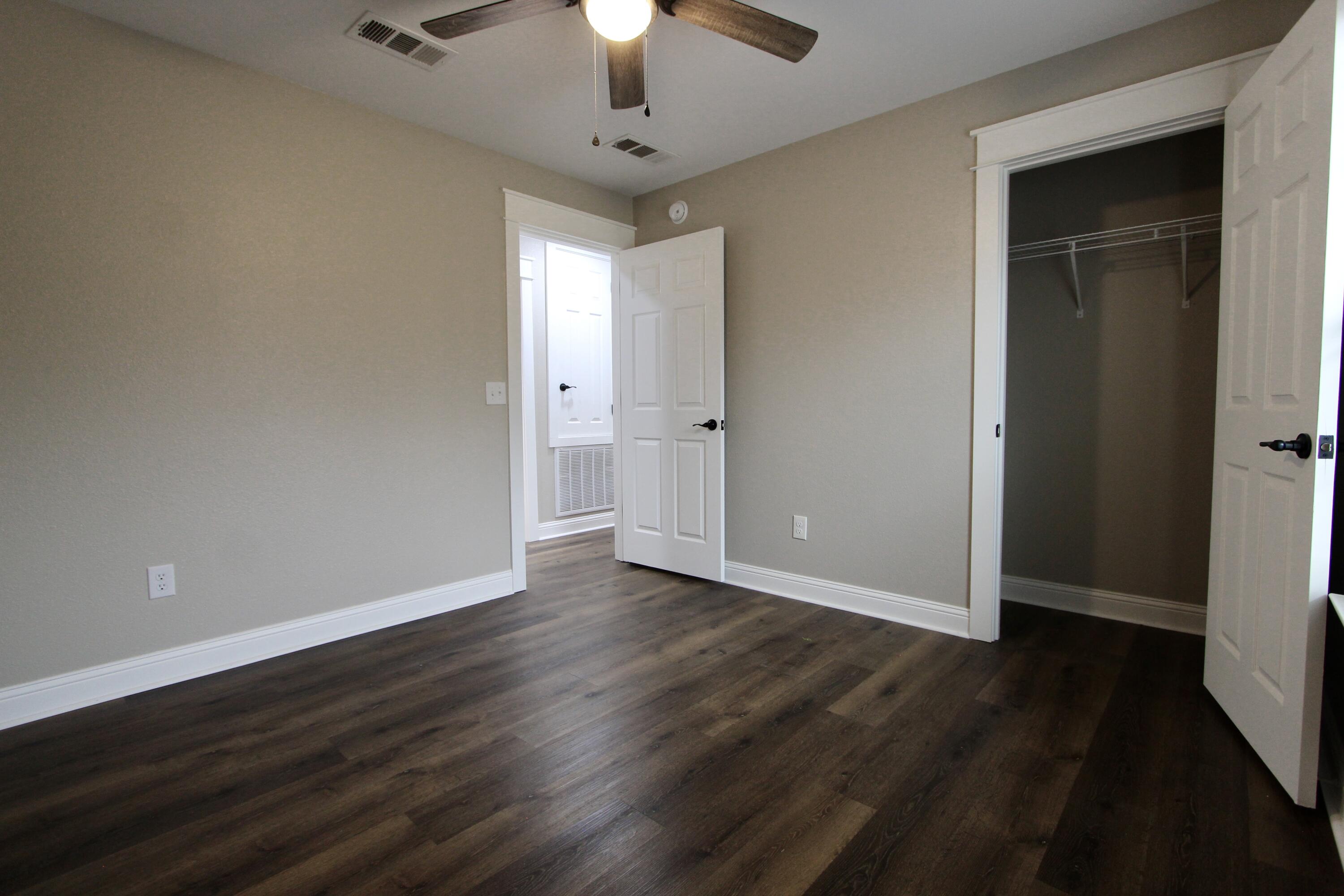4052 Randi Road Crestview, FL 32539 - Photo 16 of 27 wooden floor in an empty room with a window