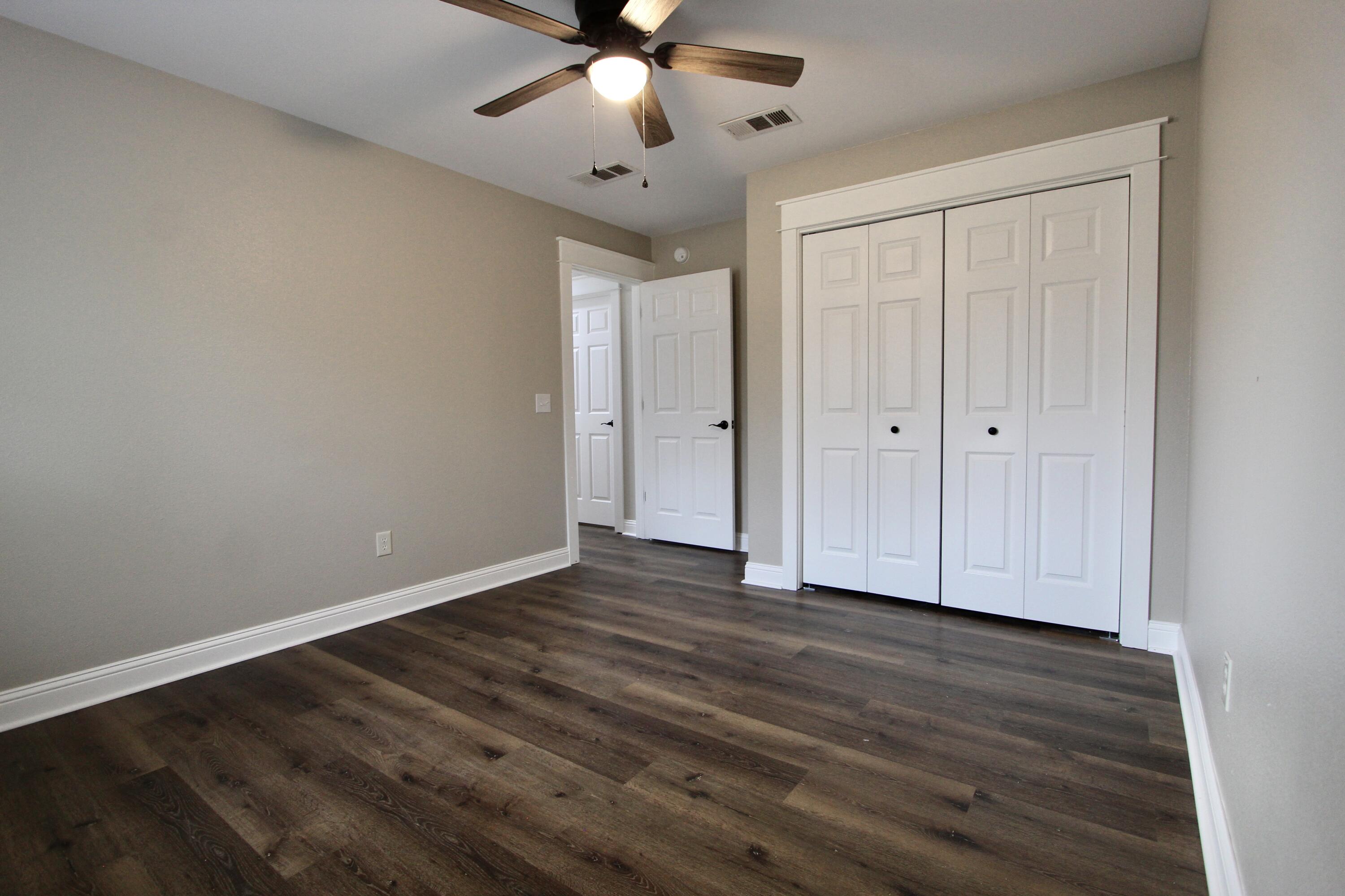4052 Randi Road Crestview, FL 32539 - Photo 18 of 27 a view of an empty room with wooden floor