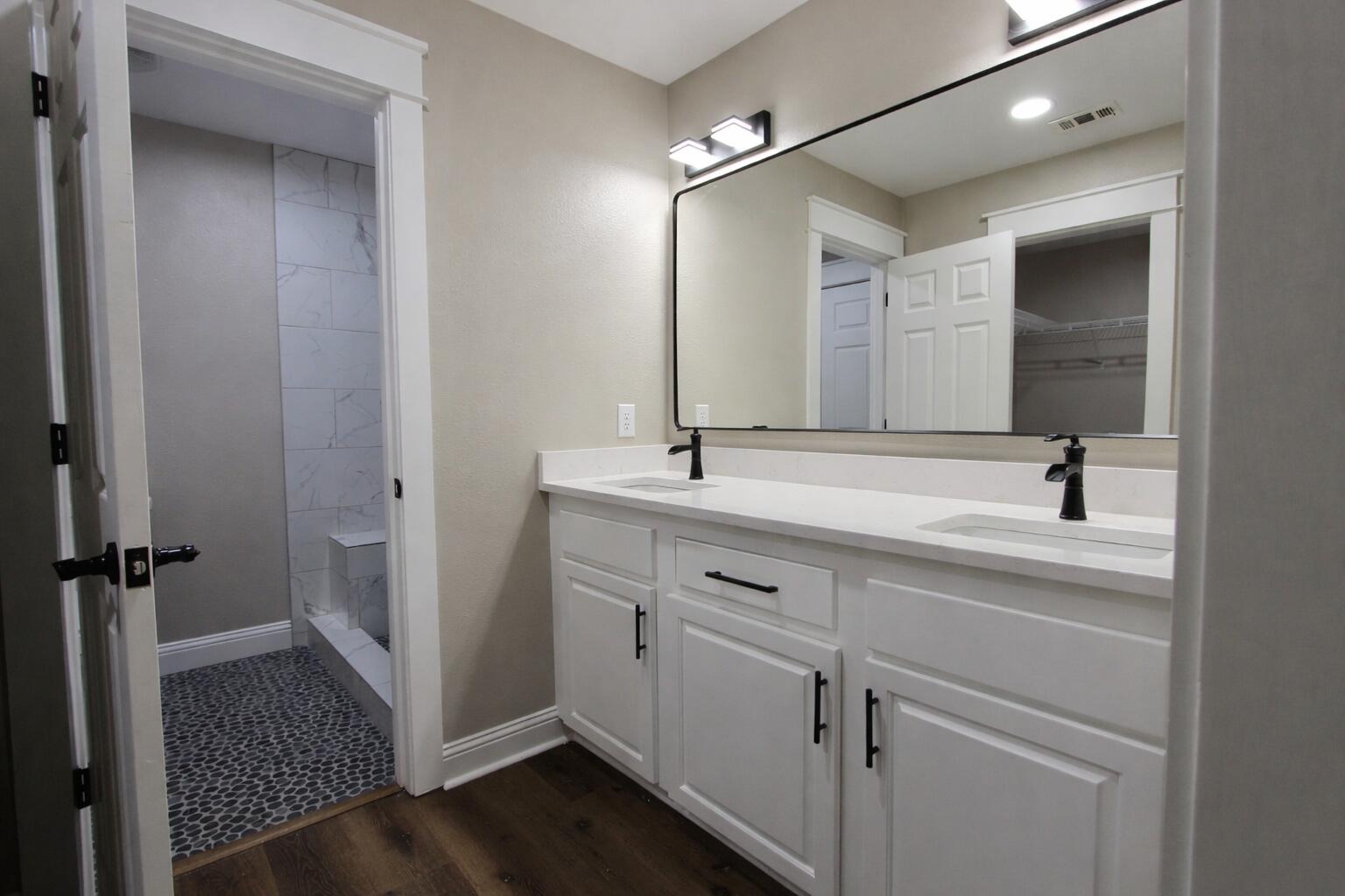 4052 Randi Road Crestview, FL 32539 - Photo 22 of 27 a bathroom with a sink a mirror and a shower