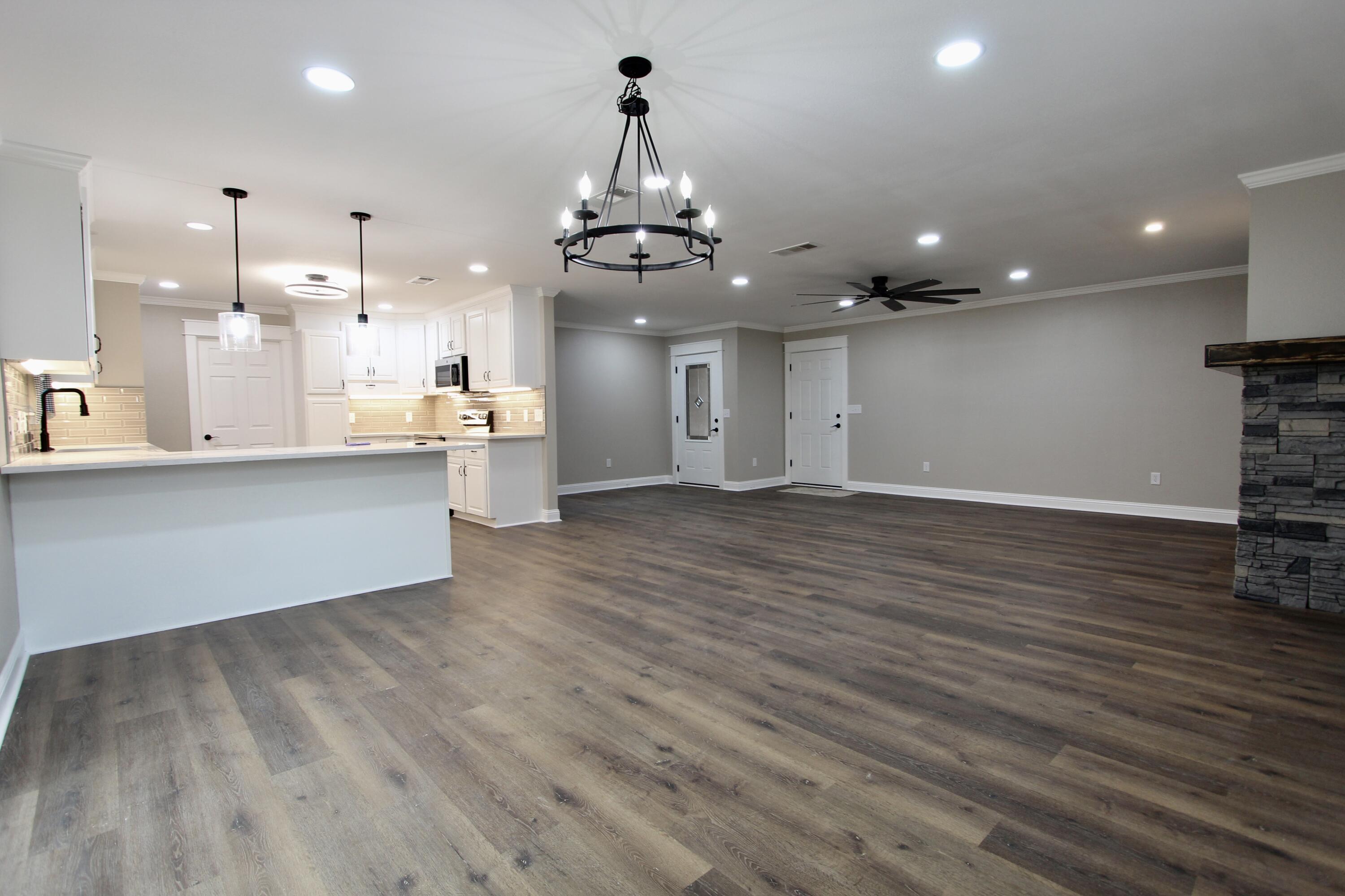 4052 Randi Road Crestview, FL 32539 - Photo 3 of 27 a view of a kitchen with granite countertop a large counter top and stainless steel appliances