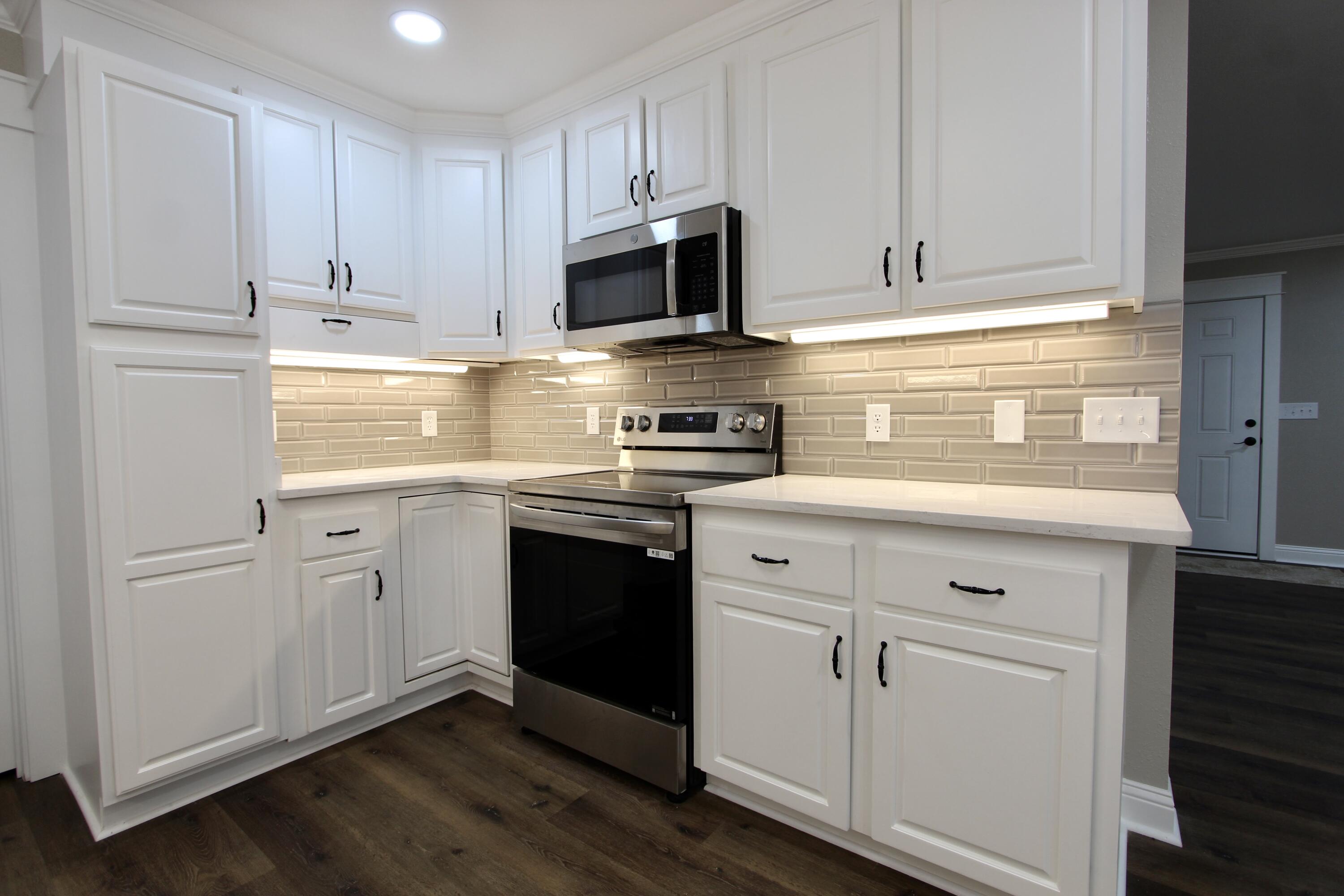 4052 Randi Road Crestview, FL 32539 - Photo 6 of 27 a kitchen with white cabinets and stainless steel appliances