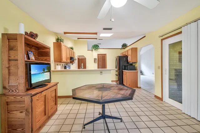 a kitchen with stainless steel appliances kitchen island granite countertop a refrigerator and cabinets
