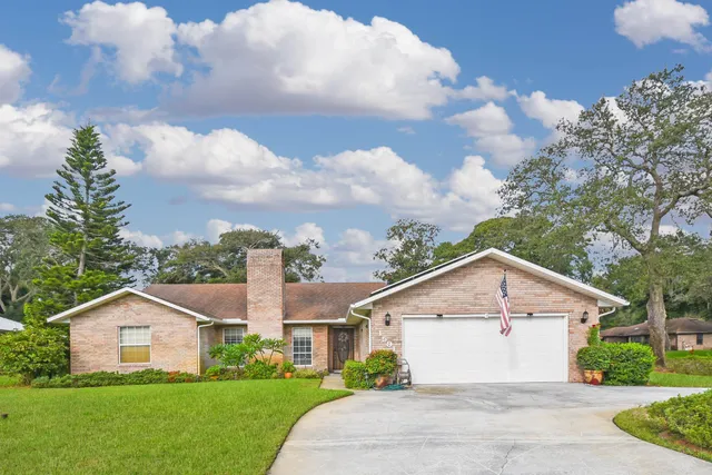 a view of house with yard and green space