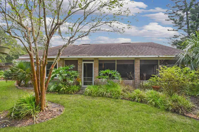 a front view of house with a garden