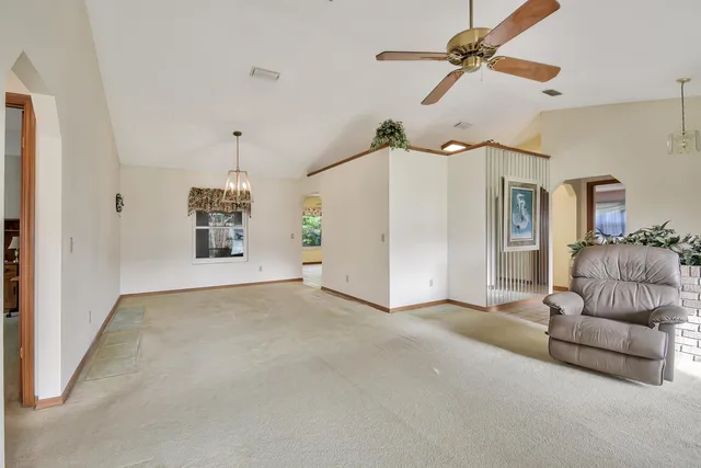 a view of a livingroom with furniture and a ceiling fan