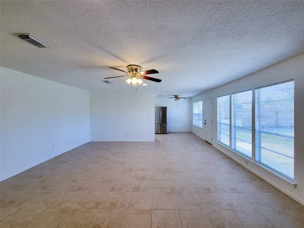 a view of a livingroom with a ceiling fan and window