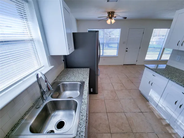 a kitchen with a sink and a refrigerator