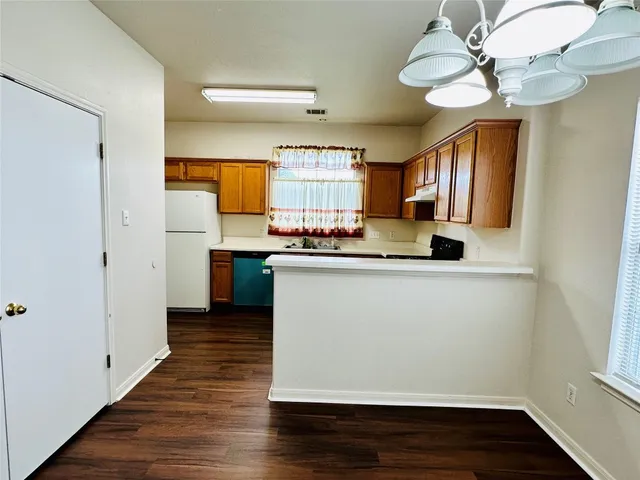 a room with wooden floor and staircase