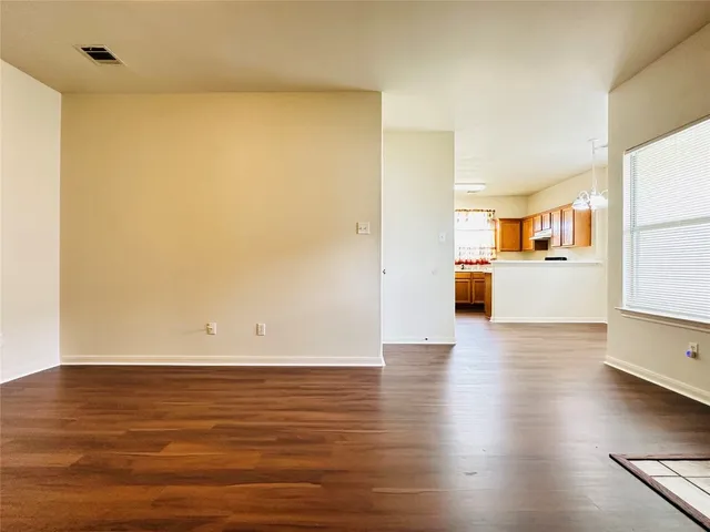 a view of a kitchen with wooden floor and a cabinet