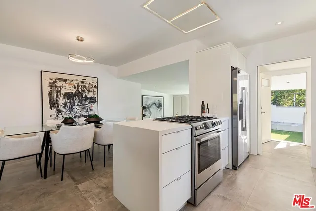 a kitchen with a stove and a refrigerator
