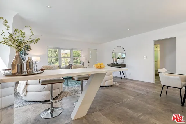 a living room with fireplace furniture and a potted plant
