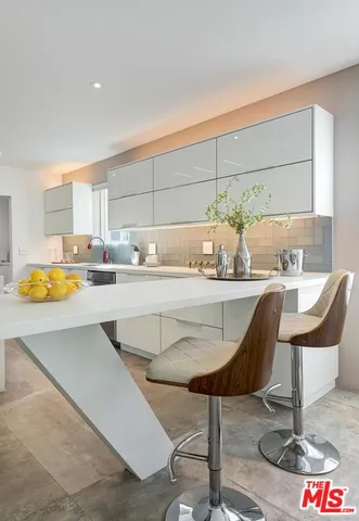a kitchen with kitchen island granite countertop a table and chairs